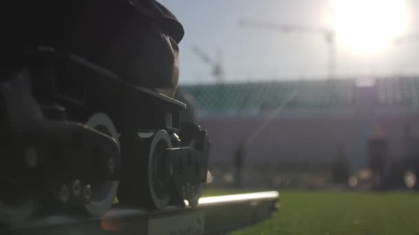 Adjusting Camera Metal Rails Football Stadium Illuminated Sunlight Filming Crew — Stockvideo