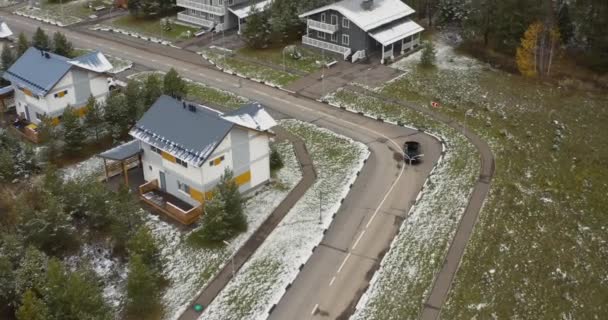 Car Drives Road Stretching Two Story Houses Built Rows Snow — Vídeo de Stock