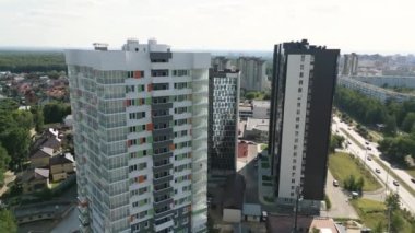 Contemporary dwelling building with stylish facade in town block on summer day aerial view. Modern urban infrastructure