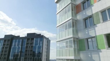 Apartment complex with highrise building in city district under blue sky aerial view. Modern architectural development