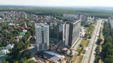 Highrise residential buildings and wide avenue in large city district on summer day bird eye view. Urban architecture