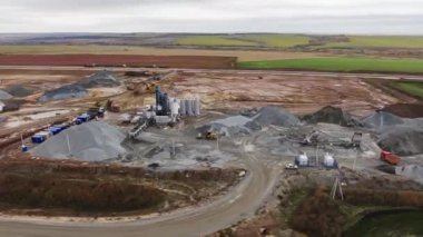 Timelapse of gravel crushing system and machinery working at open construction site with building materials aerial view