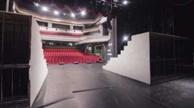 ALMATY, KAZAKHSTAN - 13 Şubat 2023: Tiyatro salonu ziyaretçi koltukları, teraslar ve sahne lambaları manzaralı. Drama tiyatrosunun iç tasarımı ve şık bir süs.