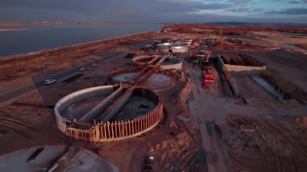 工業地域の敷地内にあるラウンド産業用貯水池 日没に川岸の丸い構成を表示する産業部門 — ストック動画