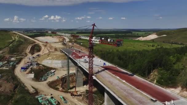 Powerful Crane Works Traffic Bridge Valley Hollow Blue Sky Construction — Stock Video