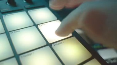 DJ konser salonunun yakın çekiminde lazer şov stroboskobu etkisi için konsolda hızlı tuşa basar. Performans projektörleri partide parlıyor