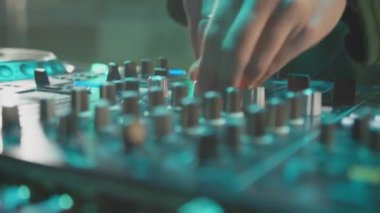 ALMATY, KAZAKHSTAN - 21 Şubat 2024: Müzisyen gece kulübünde müzik konsolunu kapatıyor. DJ dans pistinde parti misafiri olarak dans setini canlandırıyor. Eğlenceli gece hayatı.