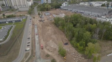 İnşaat havası manzarası altında büyük yapılar dikin. İnşaat alanı, doğa arasında geniş bir alana sahip modern mühendisliğe bir vasiyet.