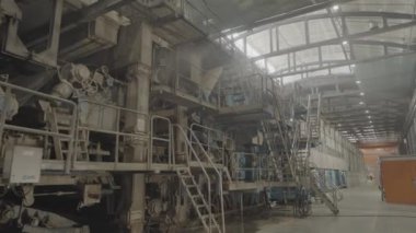 Basamakları ve yapıları olan büyük bir karton üretim atölyesi. Salon mukavva işleme makineleri ve ek ekipmanlar içerir