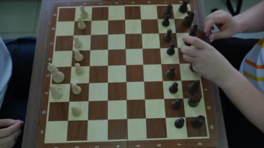 Satranç oyuncuları yoğun oyundan sonra tahta parçaları çabucak yerlerine yerleştirirler. Erkekler yeni bir cehennem satranç turu için hevesle hazırlanıyorlar.