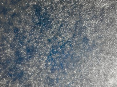 Texture of ice on the window that can be used as a handwritten background