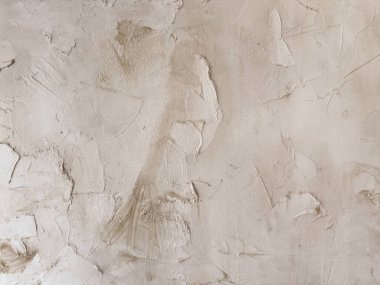 Eski taş duvarın pürüzlü yüzeyinin desenli arka planı çatlaklarla dolu.