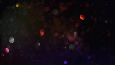 Siyah arka planda tatil soyut bokeh. Şen şakrak altın tozu. Tatil kavramı