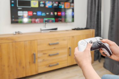 Modern oyun, eğlence ve dijital yaşam tarzını vurgulayan bir oyun denetleyicisi tutan kadın ellerinin yakın çekimi