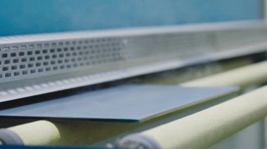 The glass goes into the machine on rollers and goes through the tempering process