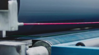 The glass goes into the machine on rollers and goes through the tempering process