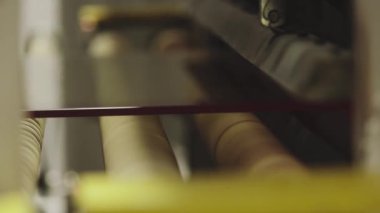 The glass goes into the machine on rollers and goes through the tempering process