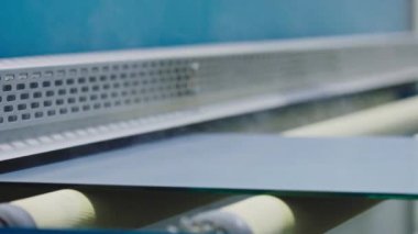 The glass goes into the machine on rollers and goes through the tempering process