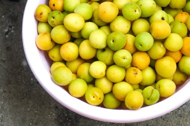 Yakın plan taze sarı erikler, açık yeşil erikler.