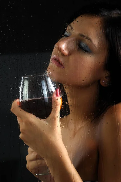 Young Woman Holding Red Wine Behing Window Drops — Stock Photo, Image