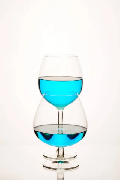 glasses of blue wine with a white background