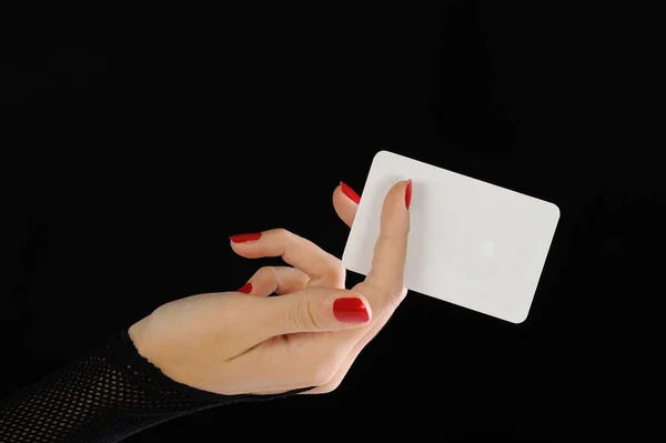 stock image hands of women holding a black and white card, on a dark background with a hand