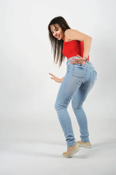 Young Beautiful Woman Red Shirt Blue Jeans White Background Her — Stock Photo, Image