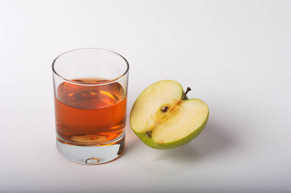 Glass of apple juice and apple on a white background. Isolated