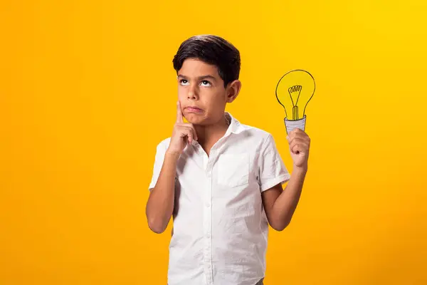 Child boy holding paper bulb. Success, motivation, winner, genius, idea concept