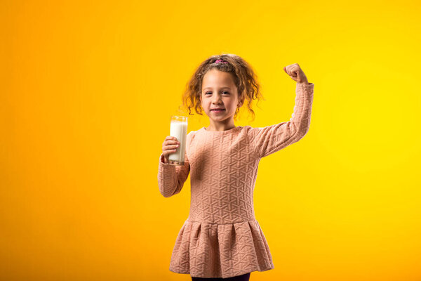 Portrait Smiling Child Girl Holding Glass Milk Showing Strenght Gesture Royalty Free Stock Photos