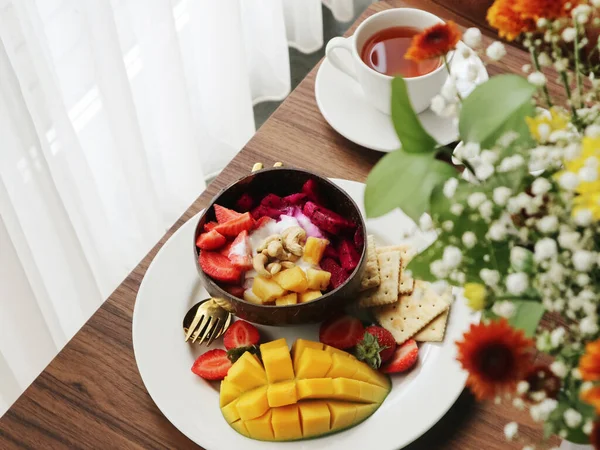 stock image Smoothie bowl with mango, strawberry, dragon fruit and cashew in coconut bowl closeup