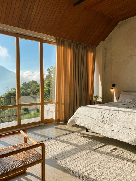 stock image Panoramic windows in  bedroom with stunning view on jungle and mountains at sunny day