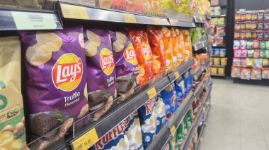 Penang, Malezya 17 Nisan 2025 çeşitli aromalı Lays patates cipsleri yerel bir süpermarketin raflarında sergileniyor..