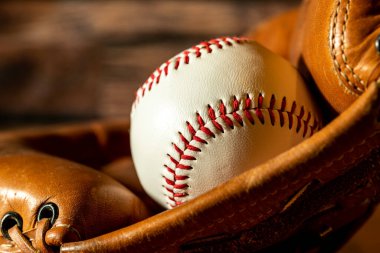 close up new white baseball isolated in leather baseball glove