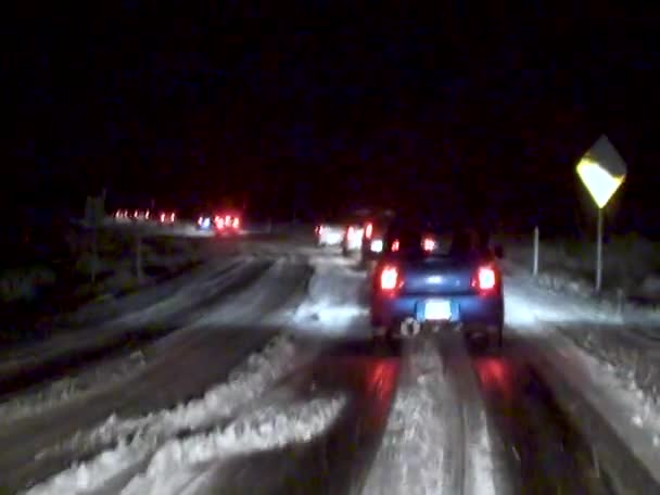 Car Drives Slowly Night Slippery Snowy Road Usa — Stockvideo