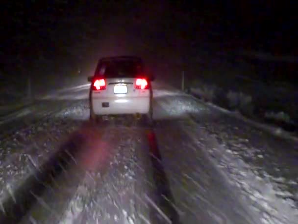 Car Drives Slowly Night Slippery Snowy Road Usa — Videoclip de stoc