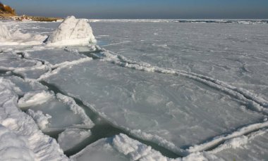 The Black Sea is frozen, ice floes float along the shore. Climate change, harsh winter