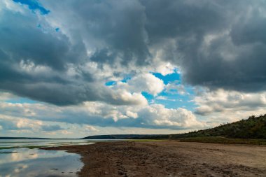 Reflection of white storm clouds in the water of the Tiligul estuary, Ukraine