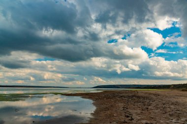 Reflection of white storm clouds in the water of the Tiligul estuary, Ukraine