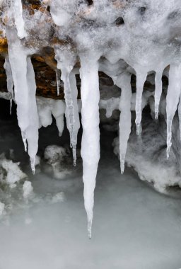 Ice icicles on frozen coastal rocks in the Black Sea