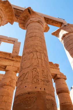 EGYPT, LUXOR - Mart 01, 2019: Luxor, Mısır 'daki Karnak' ta hiyeroglifler, çizimler ve yazıtlar içeren antik tapınak sütunları