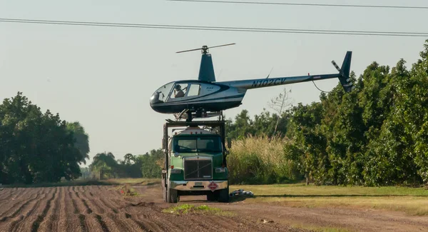 stock image USA, FLORIDA - NOVEMBER 30, 2011: An agricultural helicopter on top of a large car in a field, Florida