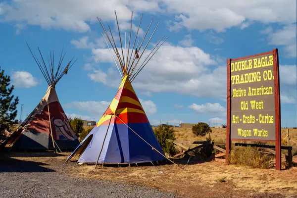 stock image Arizona, USA - November 27, 2009: Vibrant teepees stand at a desert trading post under a bright blue sky with fluffy clouds