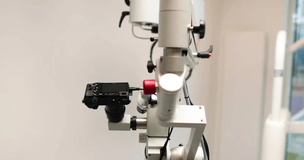 人のいない医療クリニックの内側の歯科顕微鏡のクローズアップビュー 病院の歯科オフィスで拡大とレンズを変更するプロの機器 — ストック写真