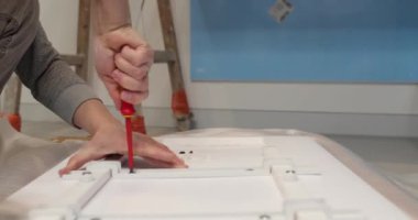 Vidaları ve cıvataları söken ya da çeviren eller ve tornavidalar yakın plan. Topla ya da parçala. Kurucunun profesyonel işi.