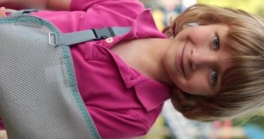 Sargısında kırık bir kolu olan yakışıklı bir çocuğun dikey çekimi. Çocuk yaraları, kırık kol, bandajlı kol..