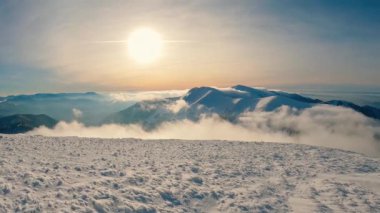 Panorama of frozen winter mountains with foggy clouds in valley in magic morning sunrise nature. Wide angle video panoramic 4K