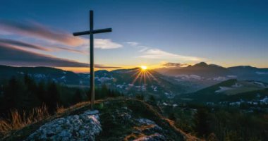 Magic Sunrise over steel christian cross religion symbol of faith and hope in top of rocky hill in autumn morning nature mountains landscape. Time lapse, Dolly shot panorama, Tilt up 4k video