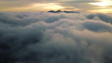 Morning Flight above misty clouds heaven in mountains nature at golden sunrise, Aerial view outdoor travel background fast motion 4k video, Fly in dreamy heaven landscape