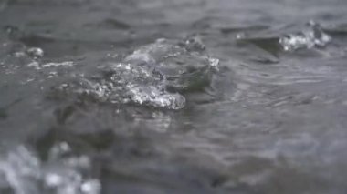 Slow motion of crystal clean water flowing in mountain stream river nature background. Copy space clear natural outdoor background